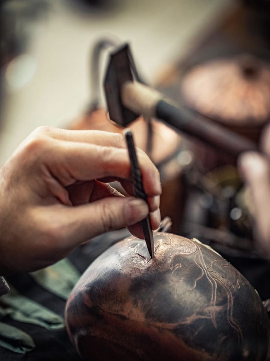 Hand-engraving a design into a metal surface